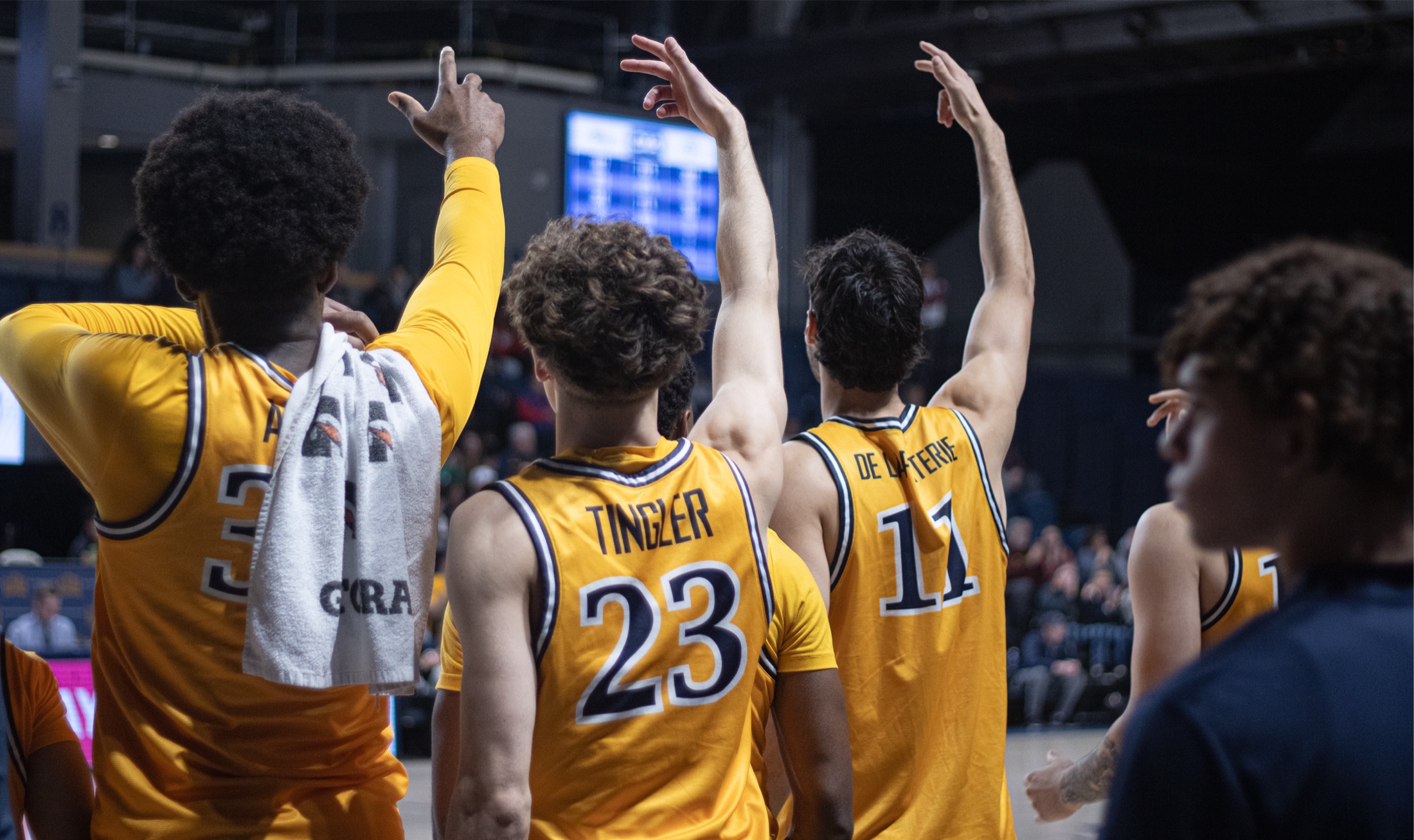 Drexel basketball players celebrating from the bench