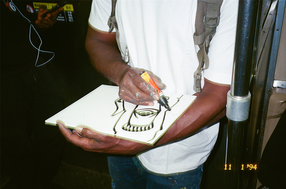 Artist drawing on a white cutout board