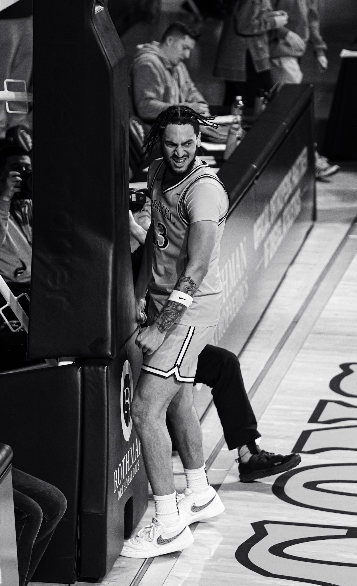 Black and white Drexel player by the baseline stanchion