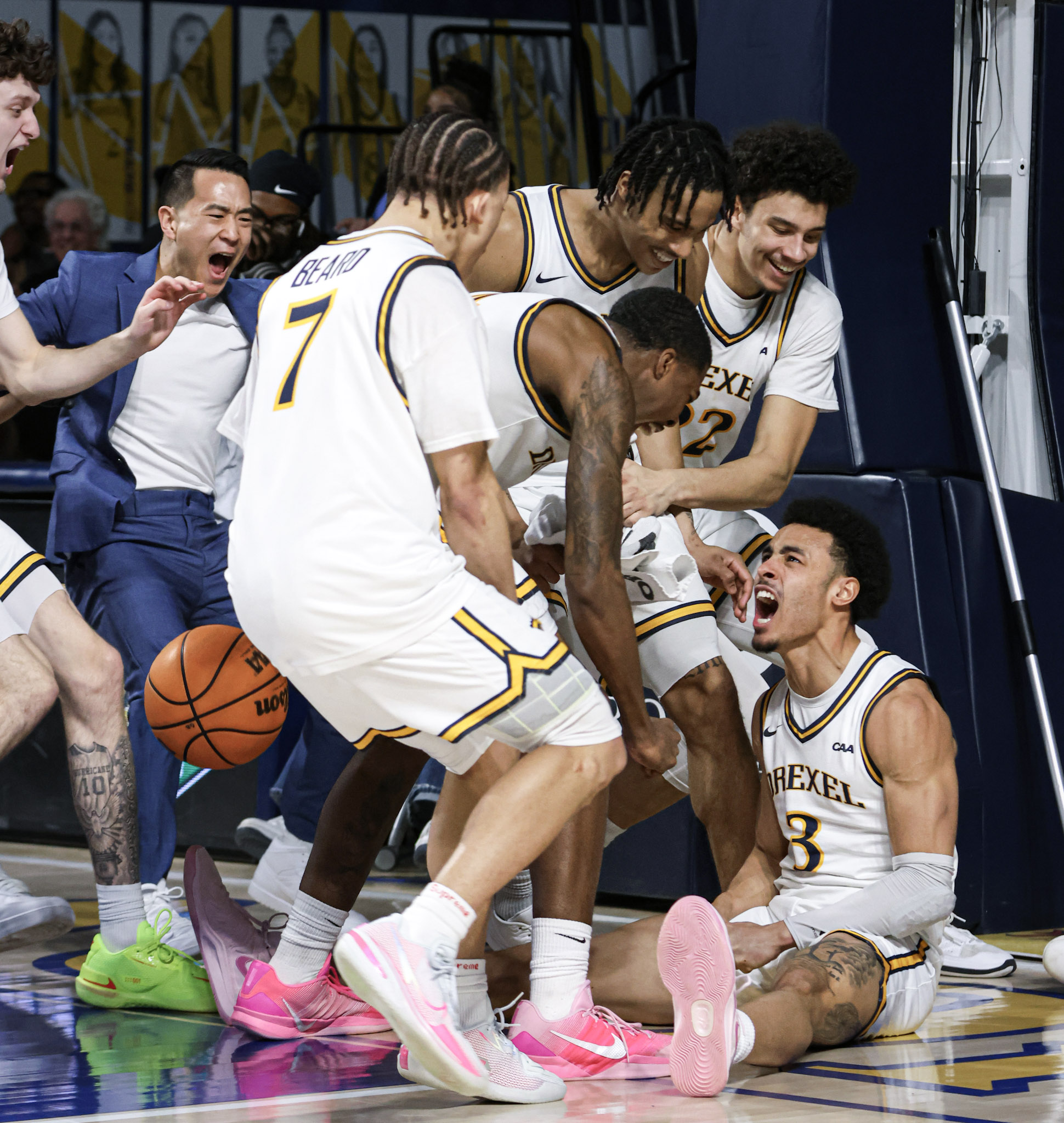 Drexel basketball team celebrating on the sideline