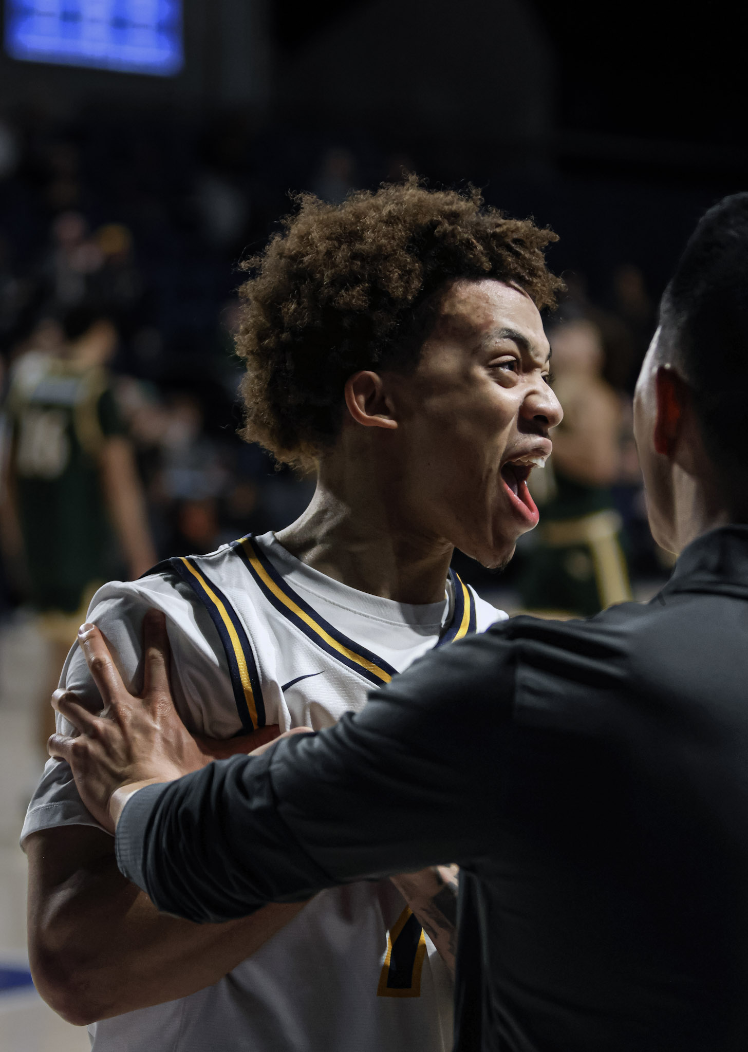 Drexel basketball player celebrating with coach