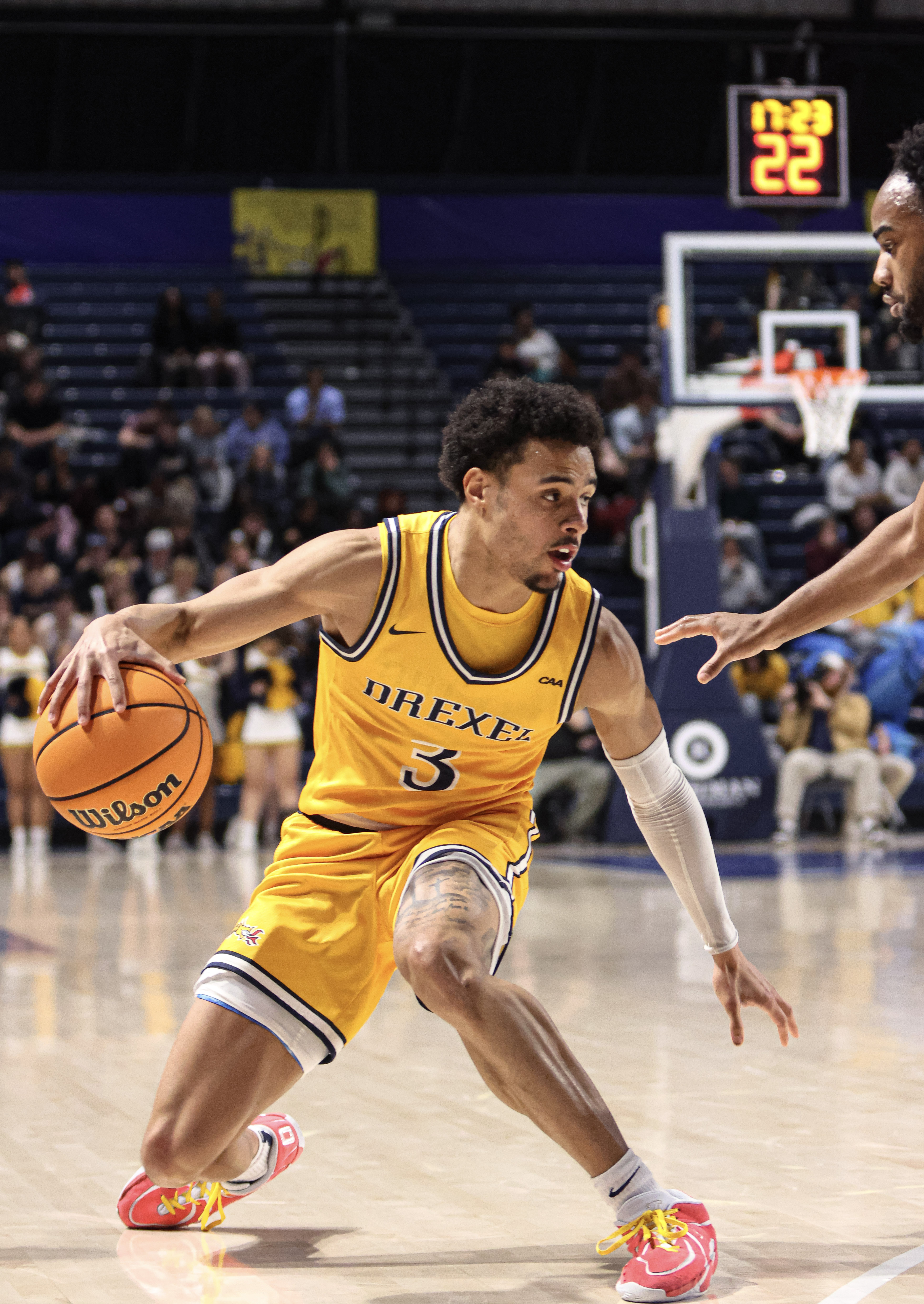 Drexel basketball player driving past a defender
