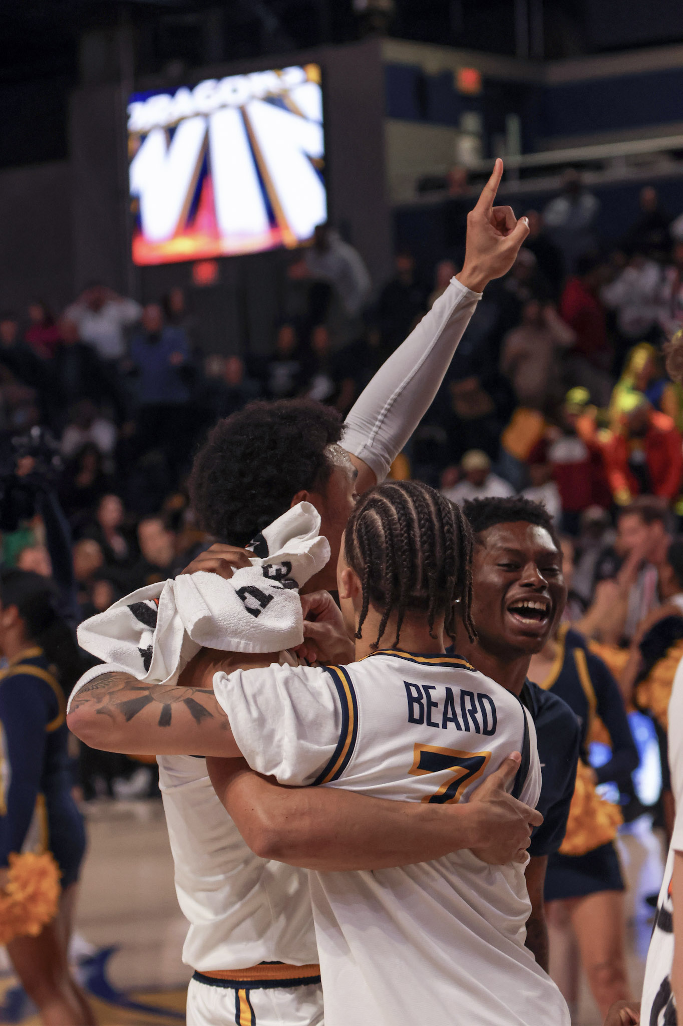 Drexel basketball players embracing after a big moment