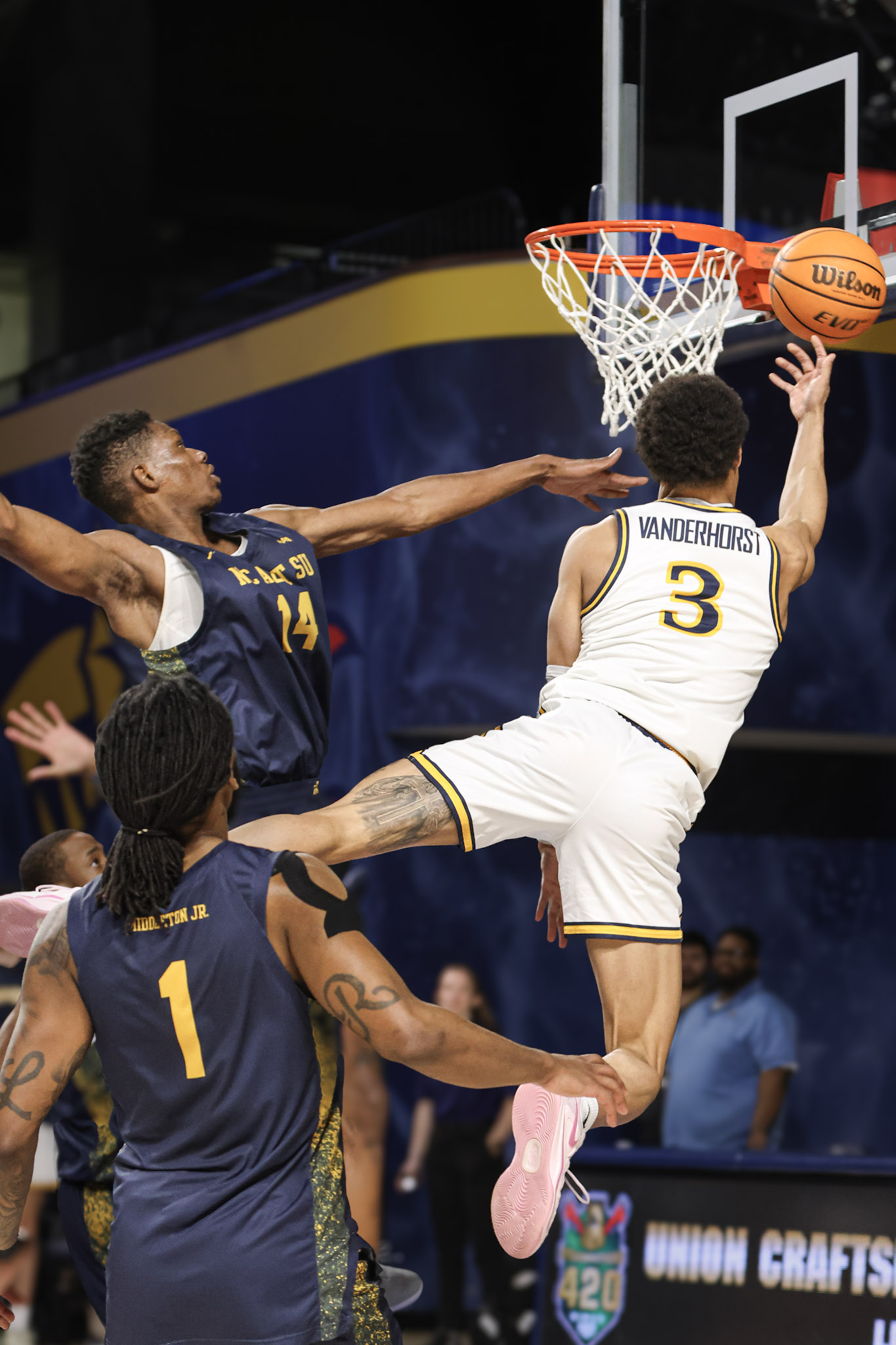 Drexel player finishing a tight reverse layup