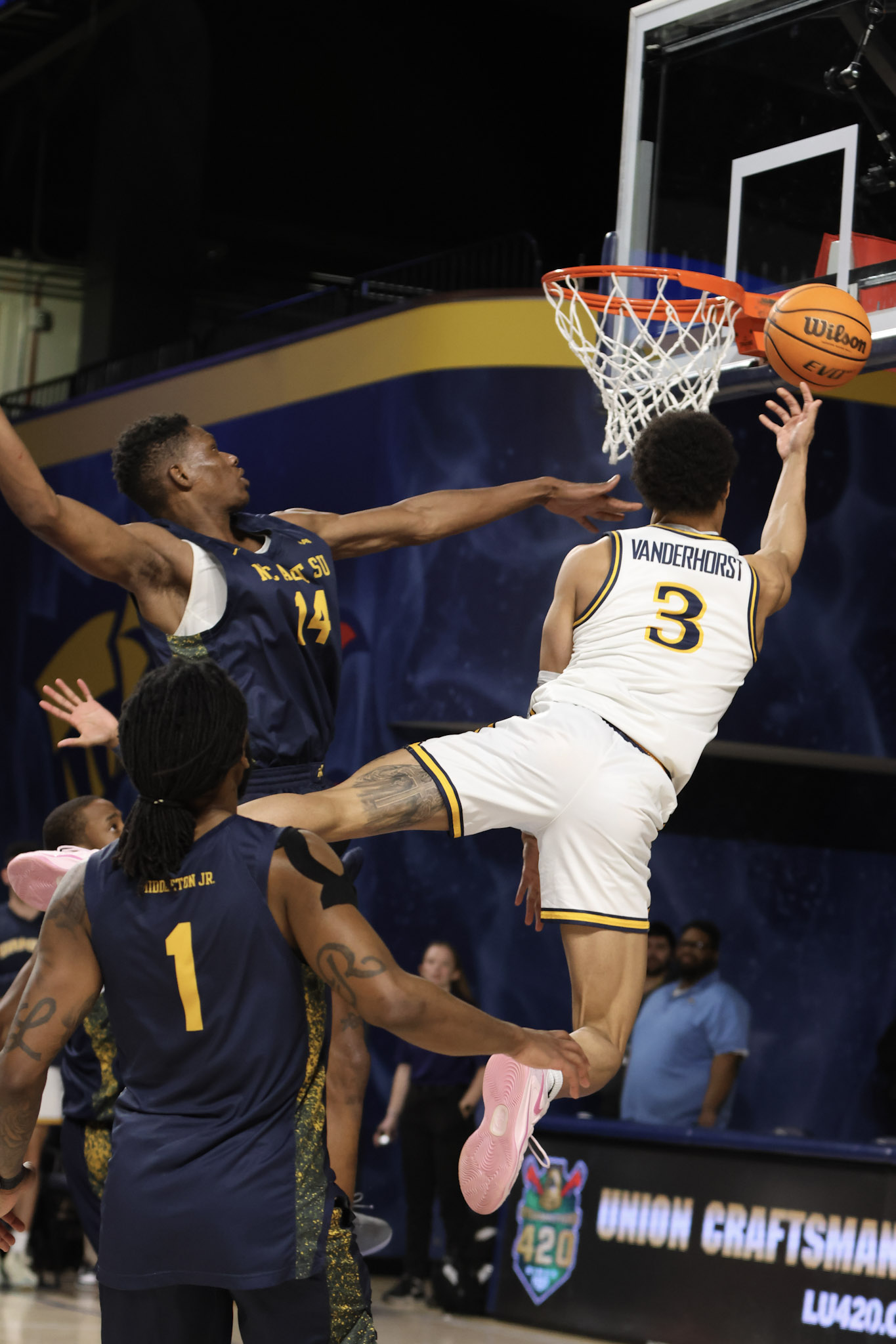 Drexel basketball player finishing a reverse layup