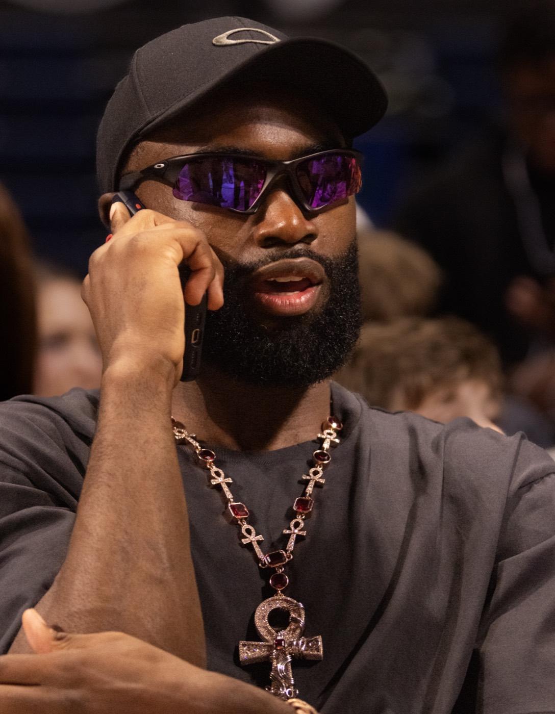 Jaylen Brown on the phone wearing sunglasses and a statement necklace
