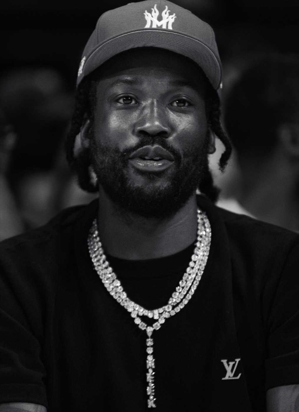 Black and white close portrait of Meek Mill wearing a diamond necklace