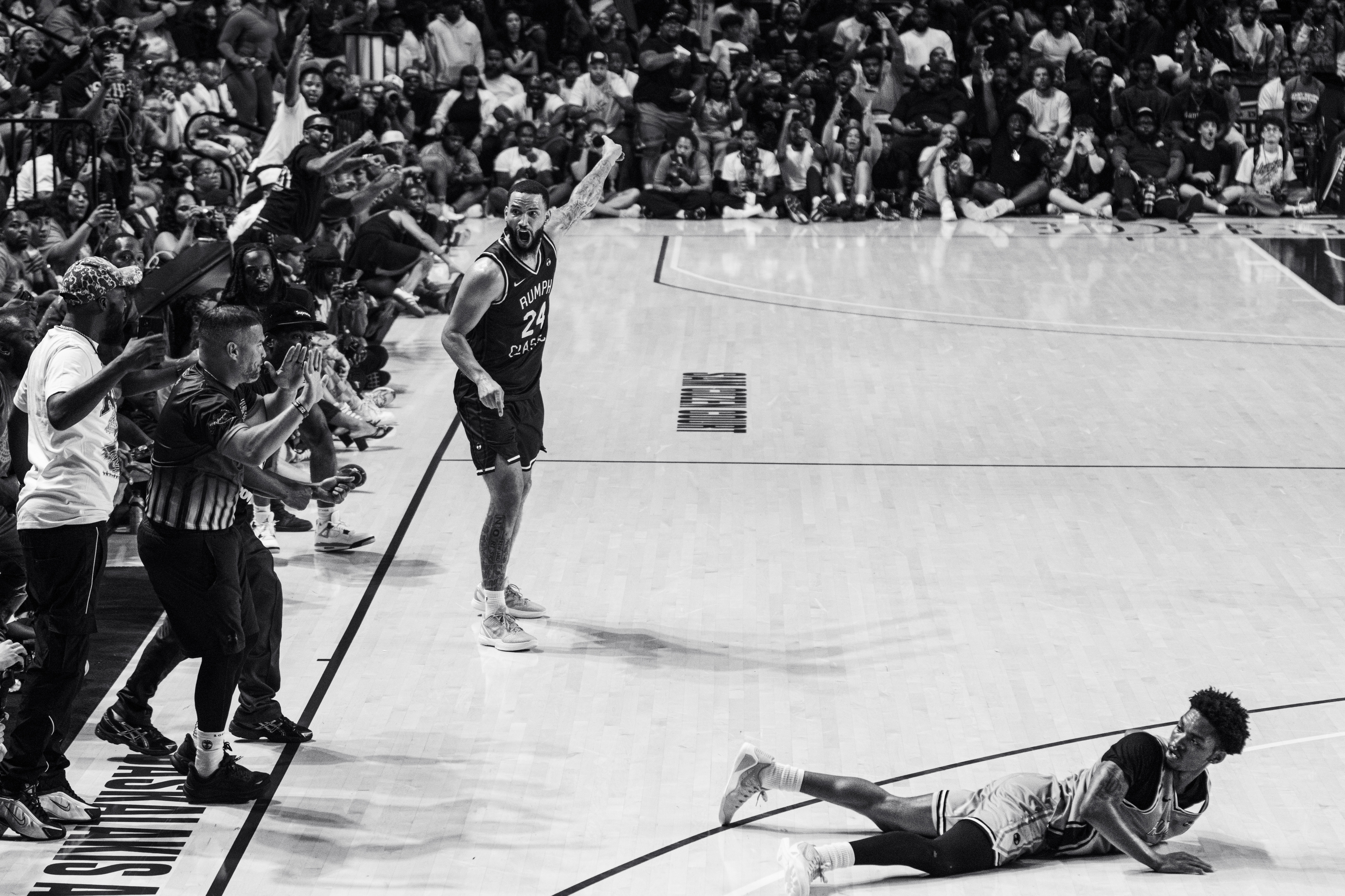 Black and white Danny Rumph Classic sideline scene with crowd surrounding the court
