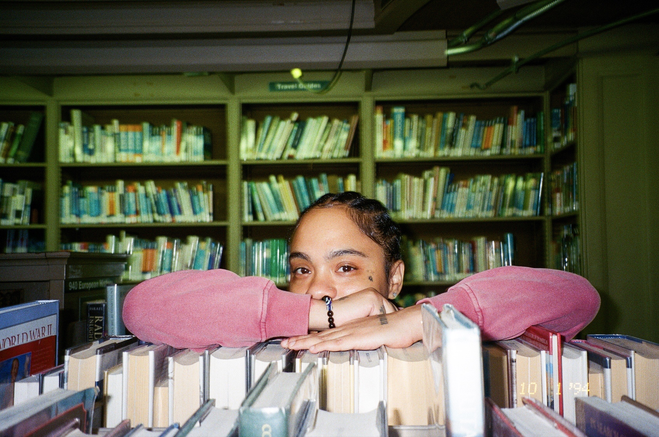 Fith and Saint portrait peeking over books