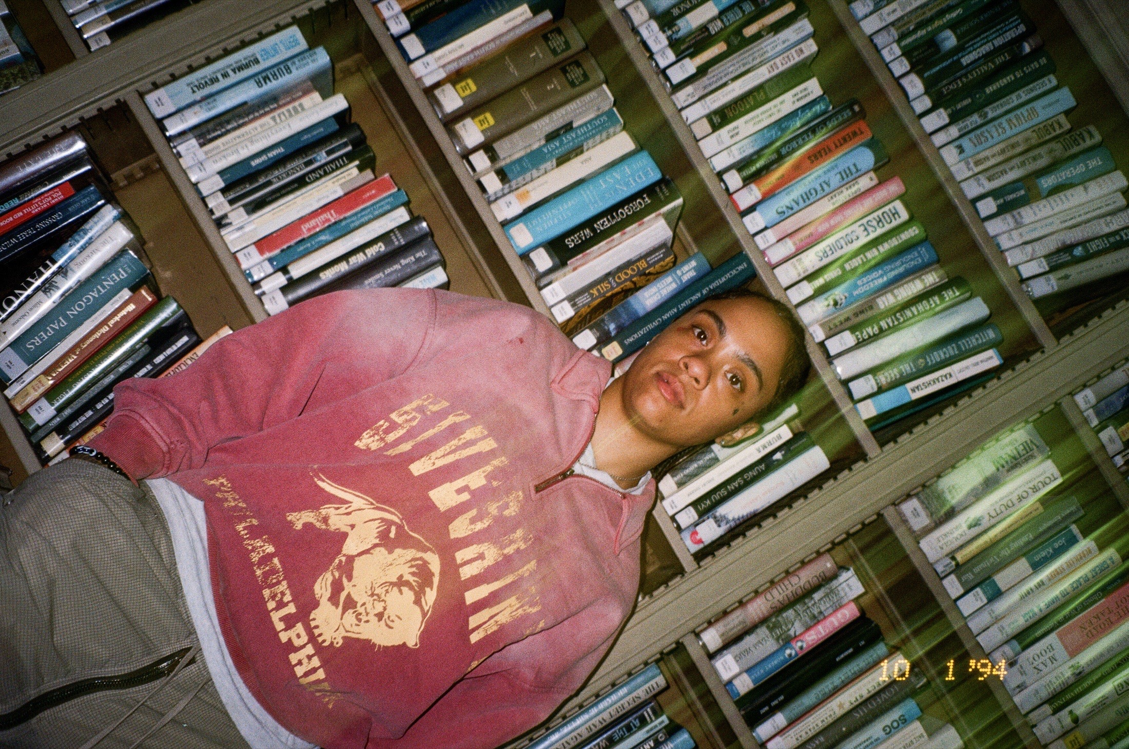 Fith and Saint tilted portrait against bookshelves