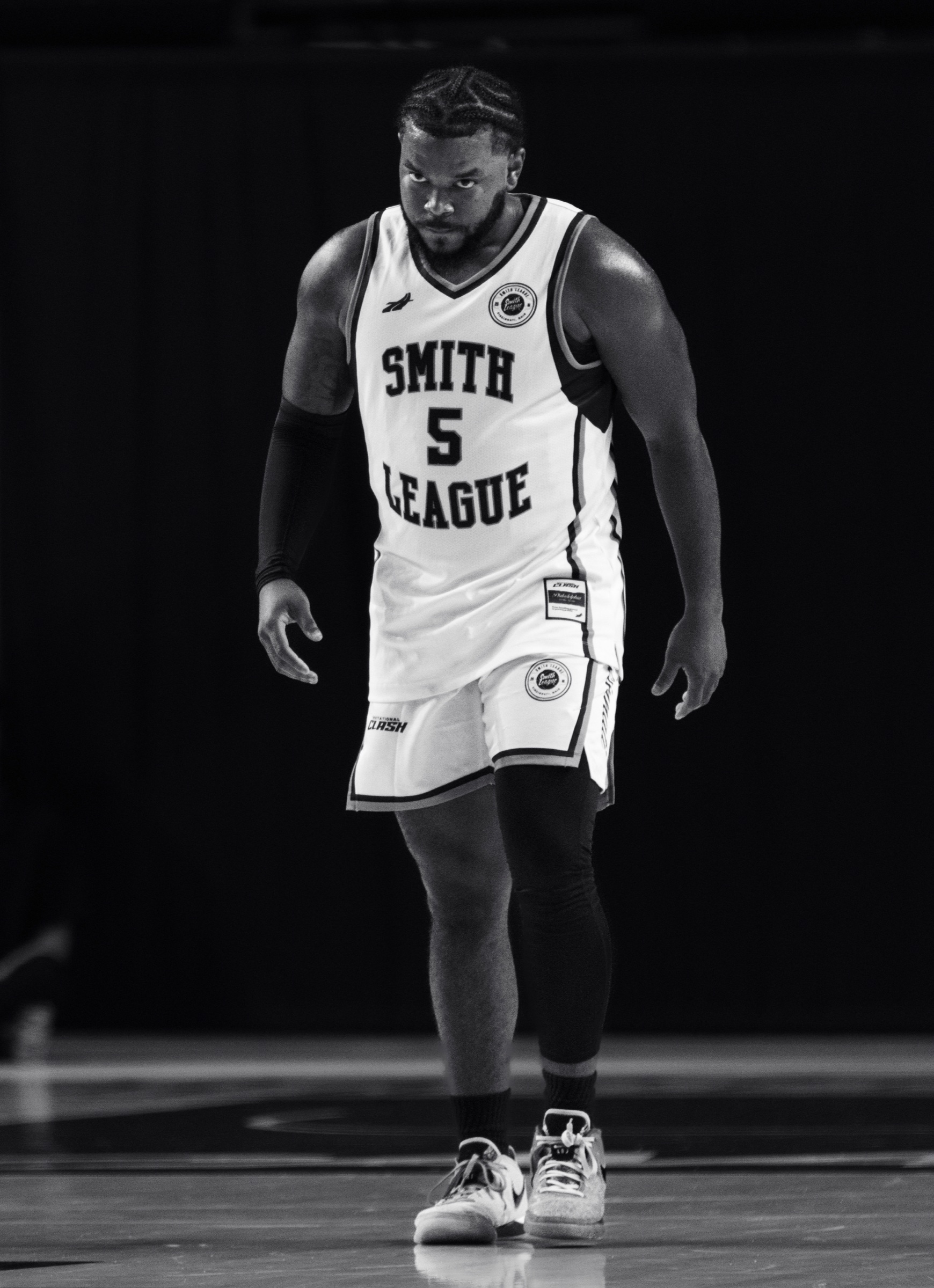 Black and white portrait of a Smith League player walking onto the court