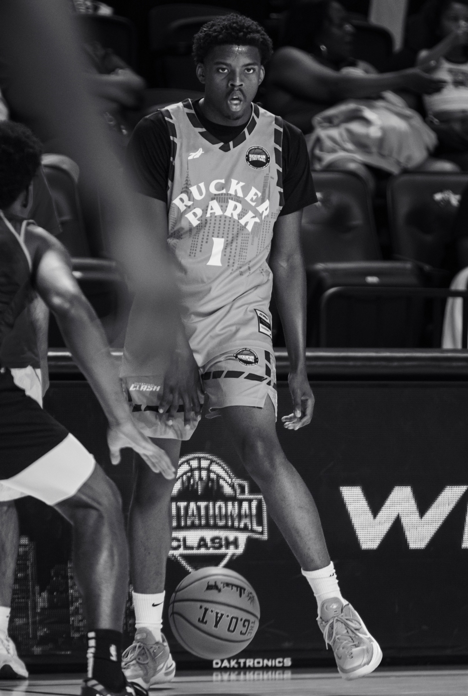 Black and white Rucker Park player dribbling at the Invitational Clash