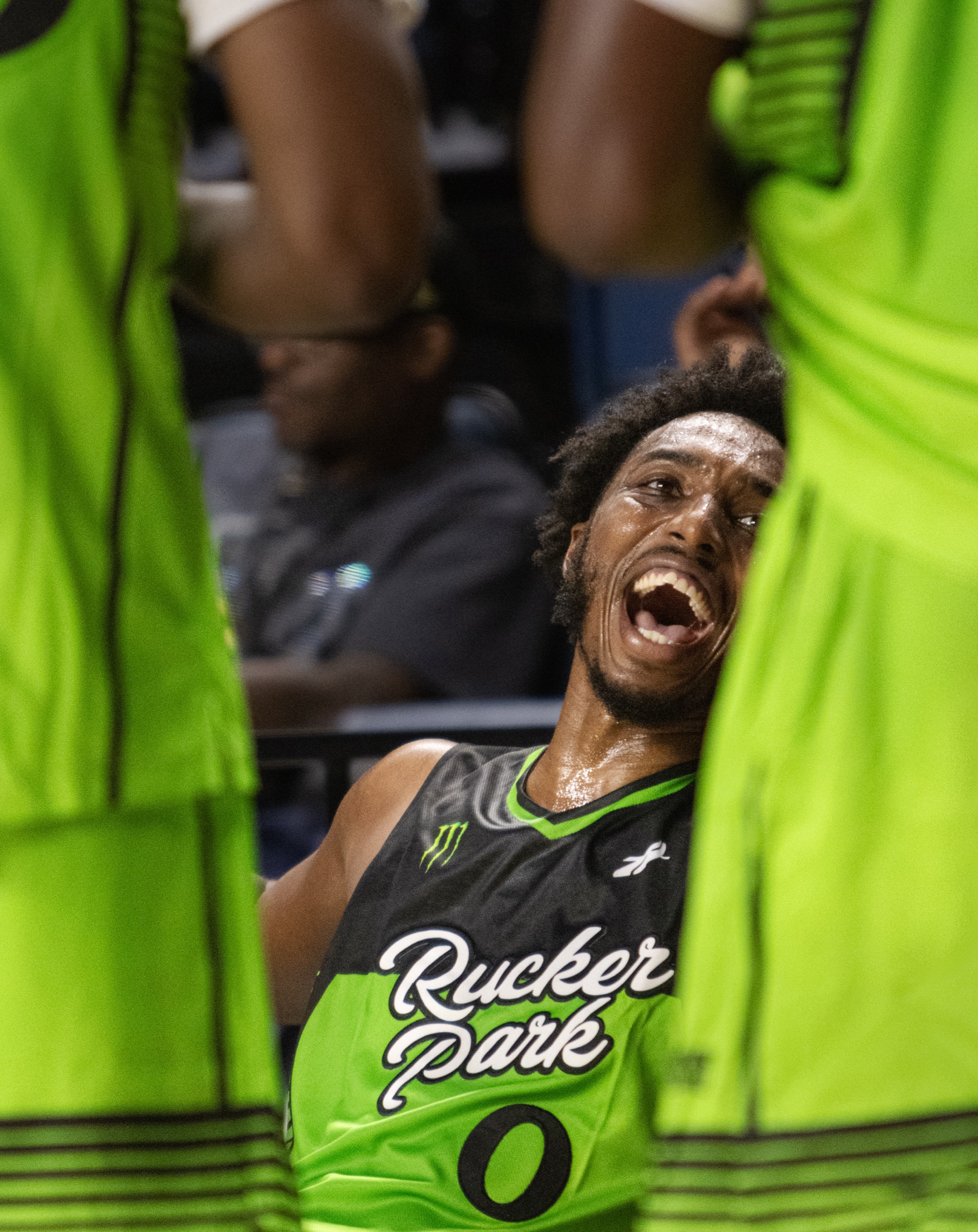 Rucker Park player celebrating with teammates on the bench
