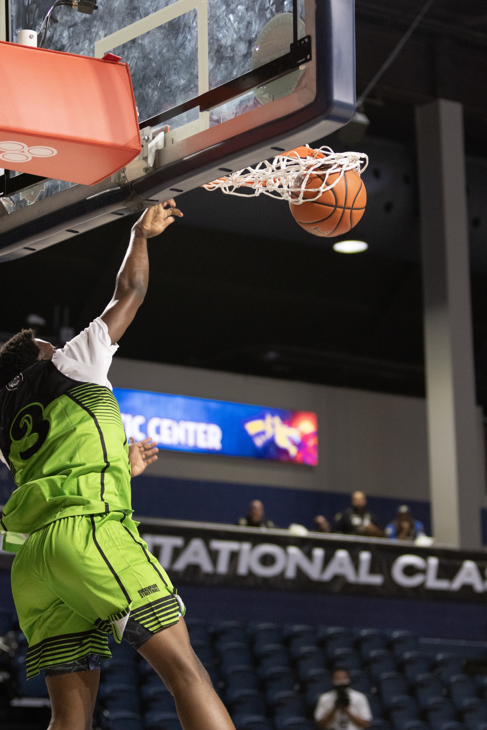 Rucker Park player dunking at the Invitational Clash