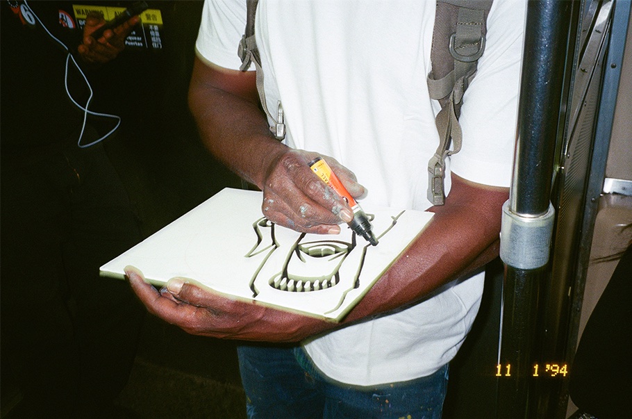 Artist painting a tile on the subway in Philadelphia